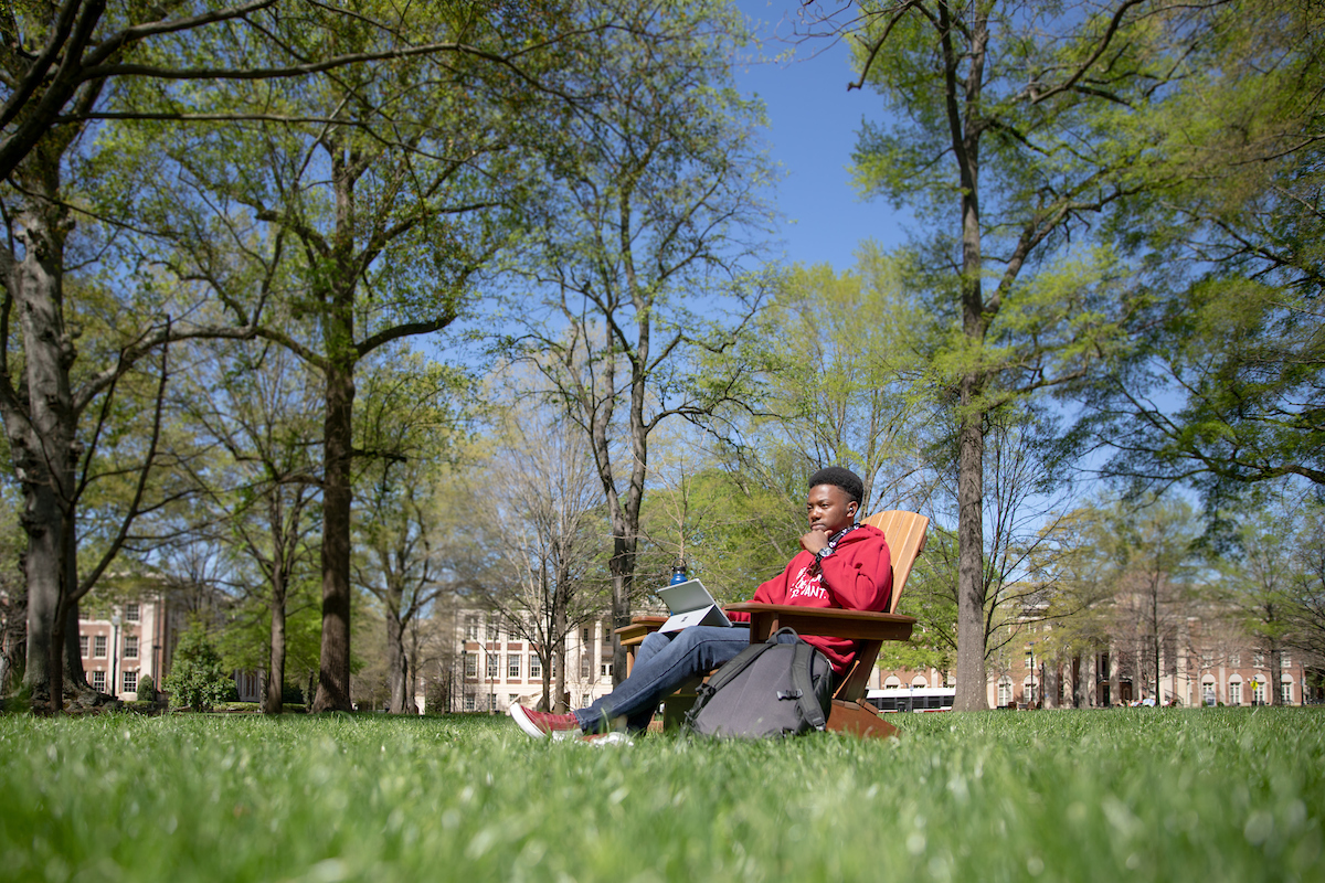 student studying in spring on the quad