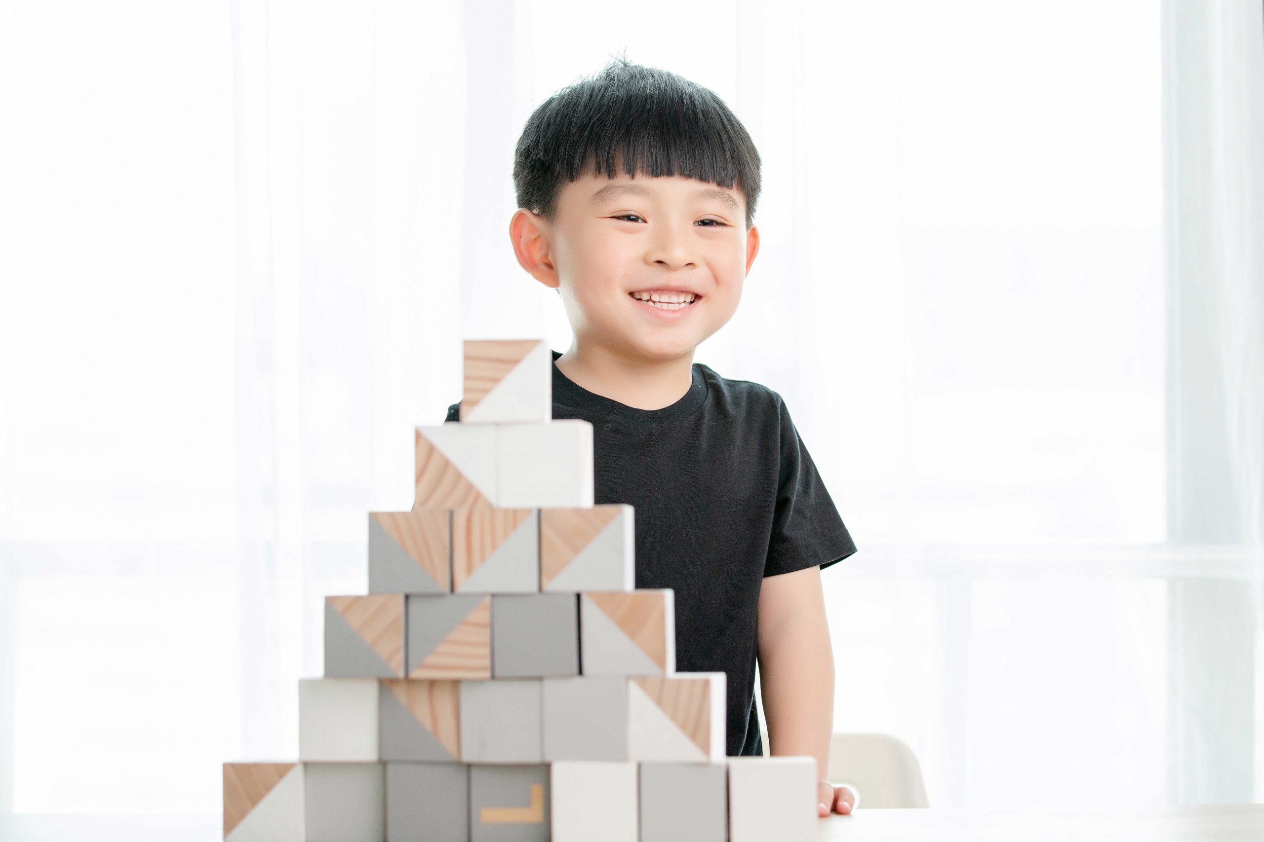 Asian little boy playing with building blocks