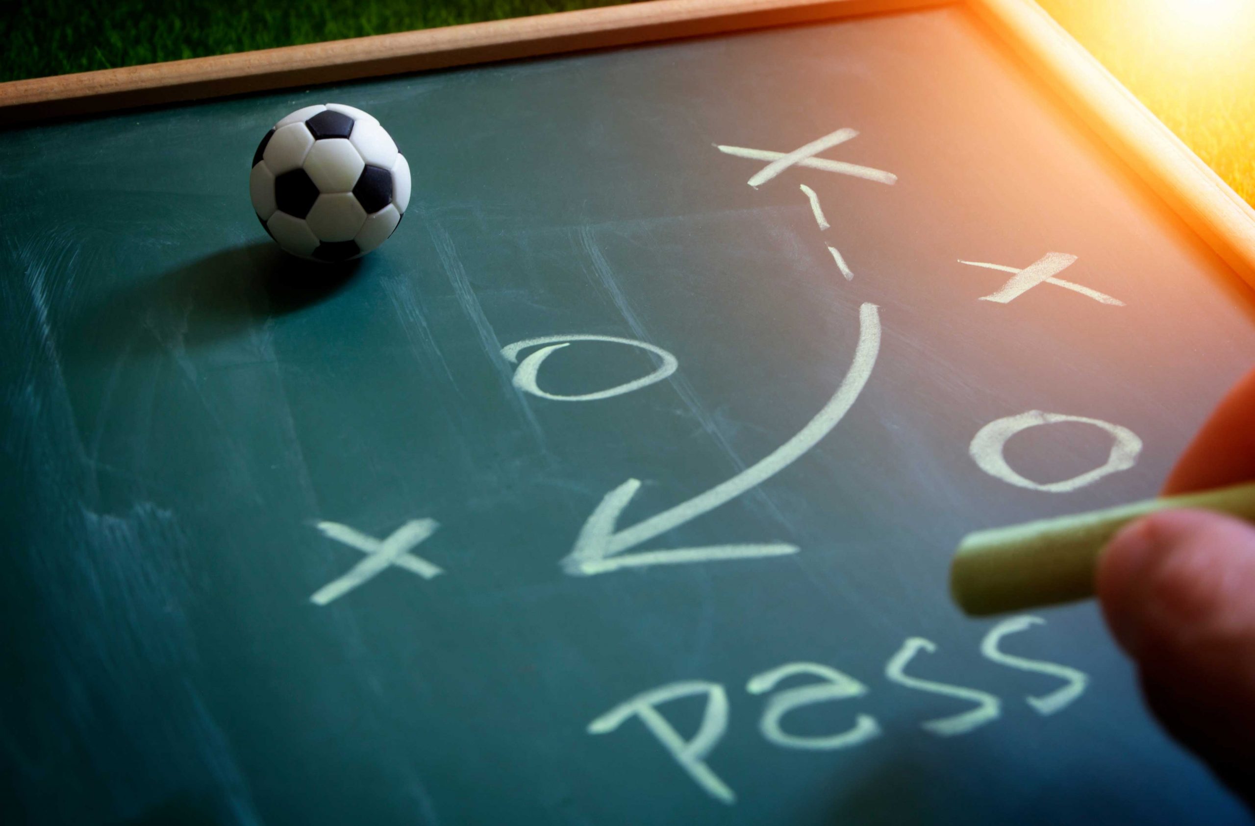 soccer manager tactical analysis on chalkboard