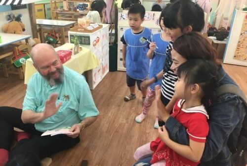 Dr. Robin McWilliam is seen working with young children and their caregiver.