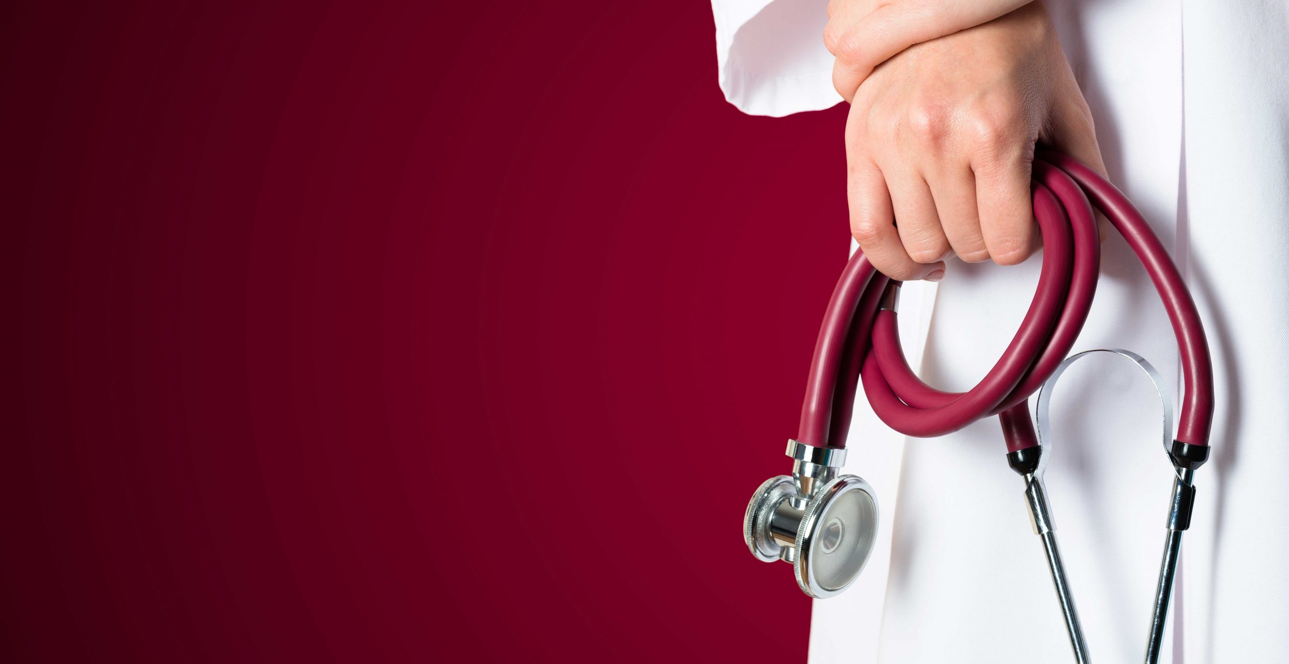 Red medical background with nurse holding stethoscope.