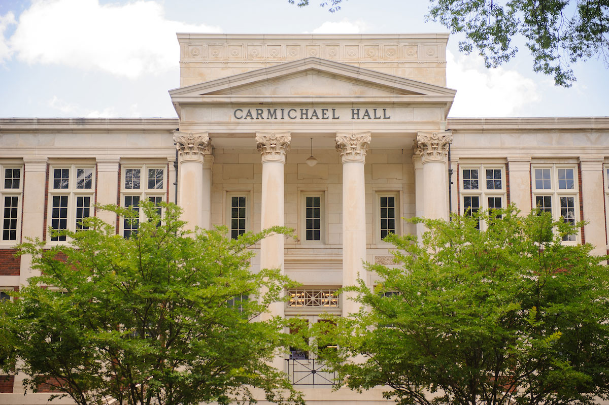 Carmichael Hall exterior framed by green trees.