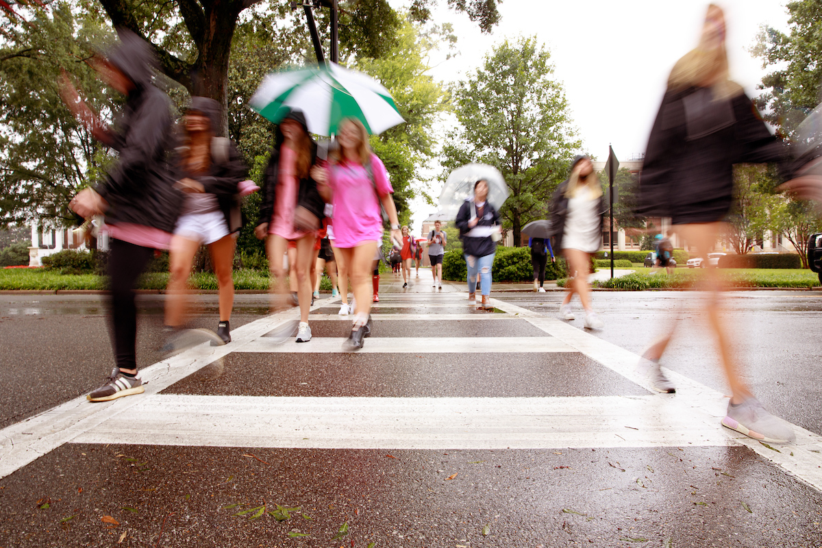 Students crossing the street in the rain