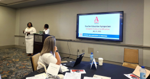 Two speakers talk with attendees of the Teacher Education Symposium on Computer Science Certification on July 21, 2025. This symposium was presented by the Alabama State Department of Education.
